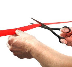 woman cutting small business red tape