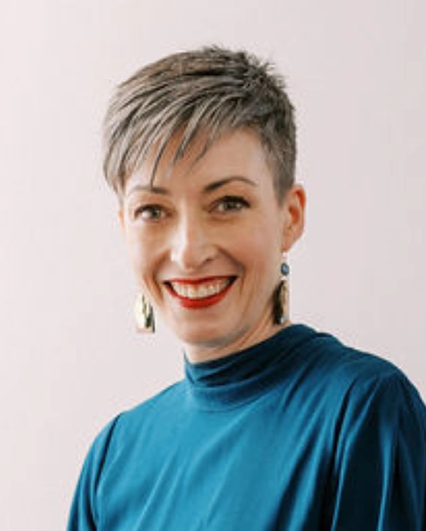 Confident woman with short hair and bright smile for HerBusiness.